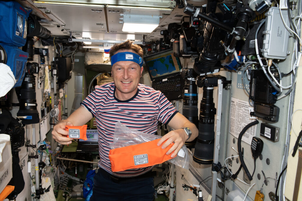 Der ESA-Astronaut Matthias Maurer mit einer Tasche voll mit „Wiener“ Dosimetern