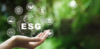 ESG icon concept in the hand for environmental, social, and governance in sustainable and ethical business on the Network connection on a green background.