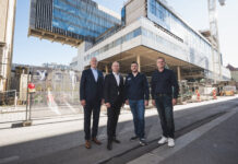 Reinhard Mayr und Christof Splechtna mit Martin Rauchenbacher und Ernst Scherer von der Zimmerei Scherer vor der Baustelle des Raiqa.