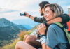 happy young couple enjoying the hike together and taking pictures