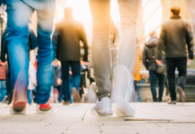 Crowd of people walking in motion in downtown rush hour