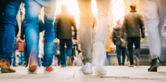 Crowd of people walking in motion in downtown rush hour