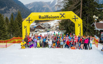 Alle Teilnehmende vor dem Zielbogen des Retro Skirennens am Sattelberg