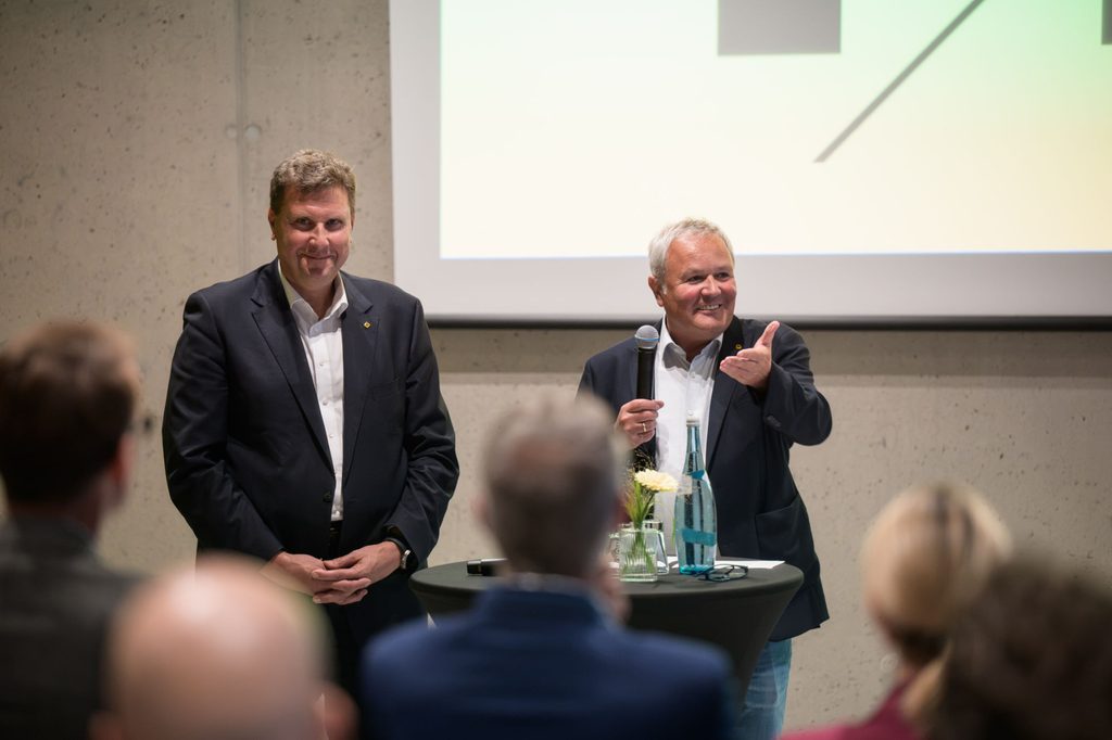 Im Frieda’s Hub im neuen RAIQA der Raiffeisen-Landesbank Tirol in Innsbruck begrüßten Thomas Wass, Vorstandsvorsitzender der Raiffeisen-Landesbank Tirol und Gerhard Cramer, Geschäftsführer Raiffeisen Immobilien Tirol, die Gäste zur Jubiläumsfeier. © RLB Tirol
